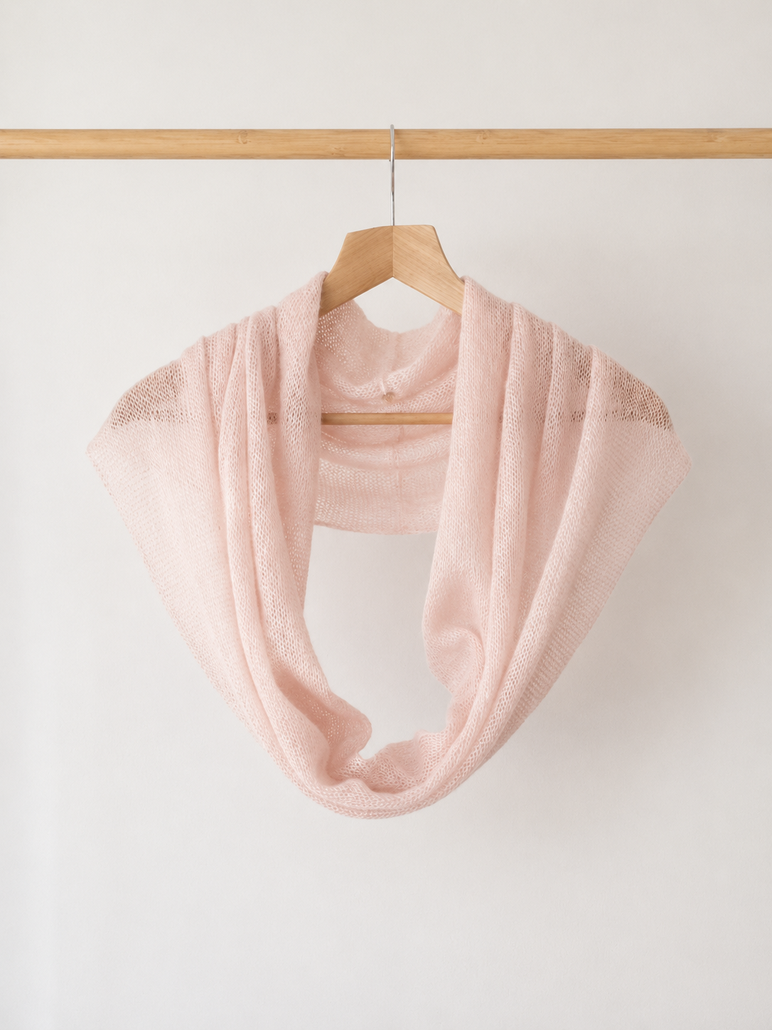 Blush Pink lightweight infinity scarf hanging on a wooden hanger.