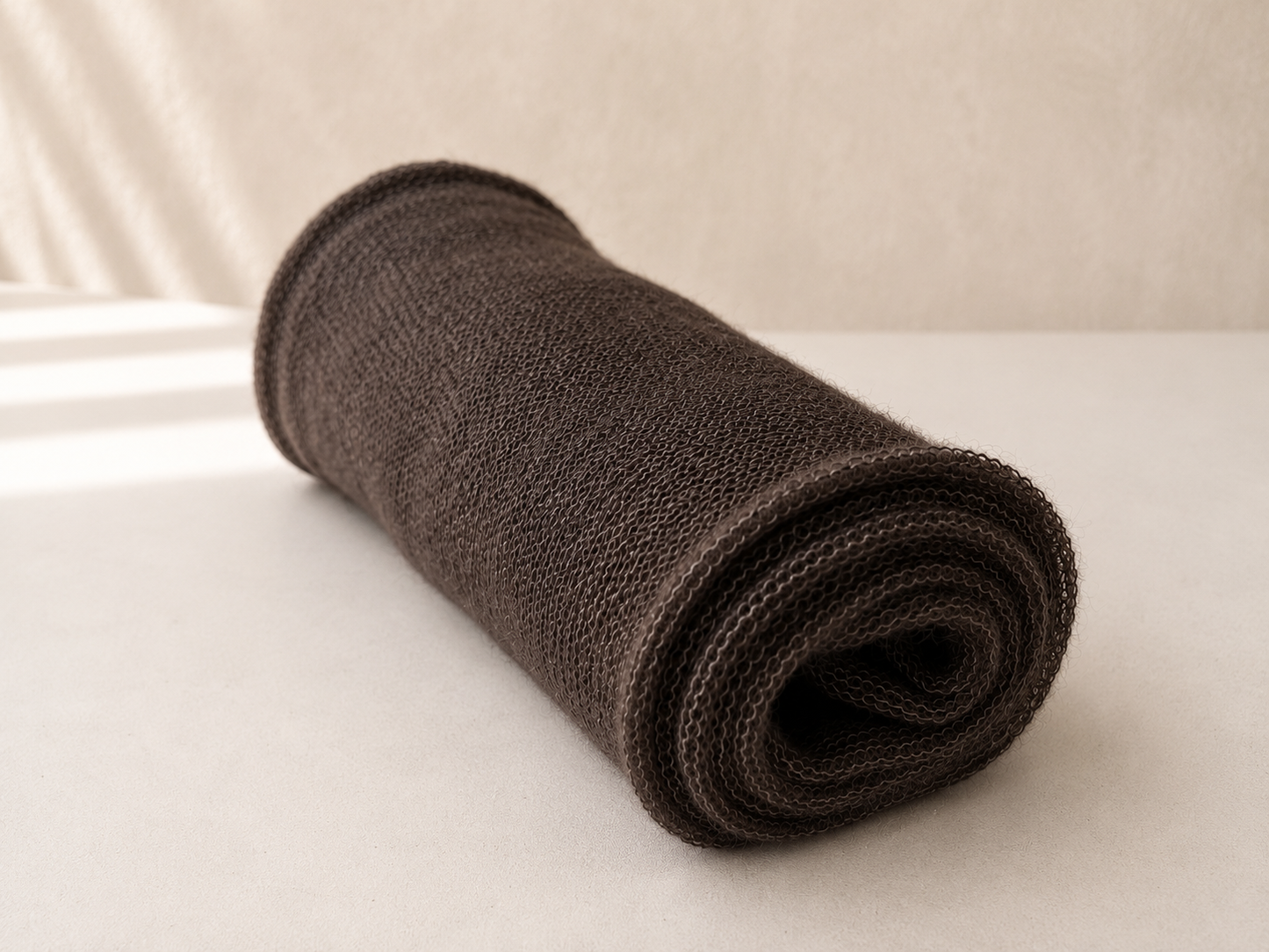Rolled Warm Taupe silk mohair shawl showing its lightweight knit texture