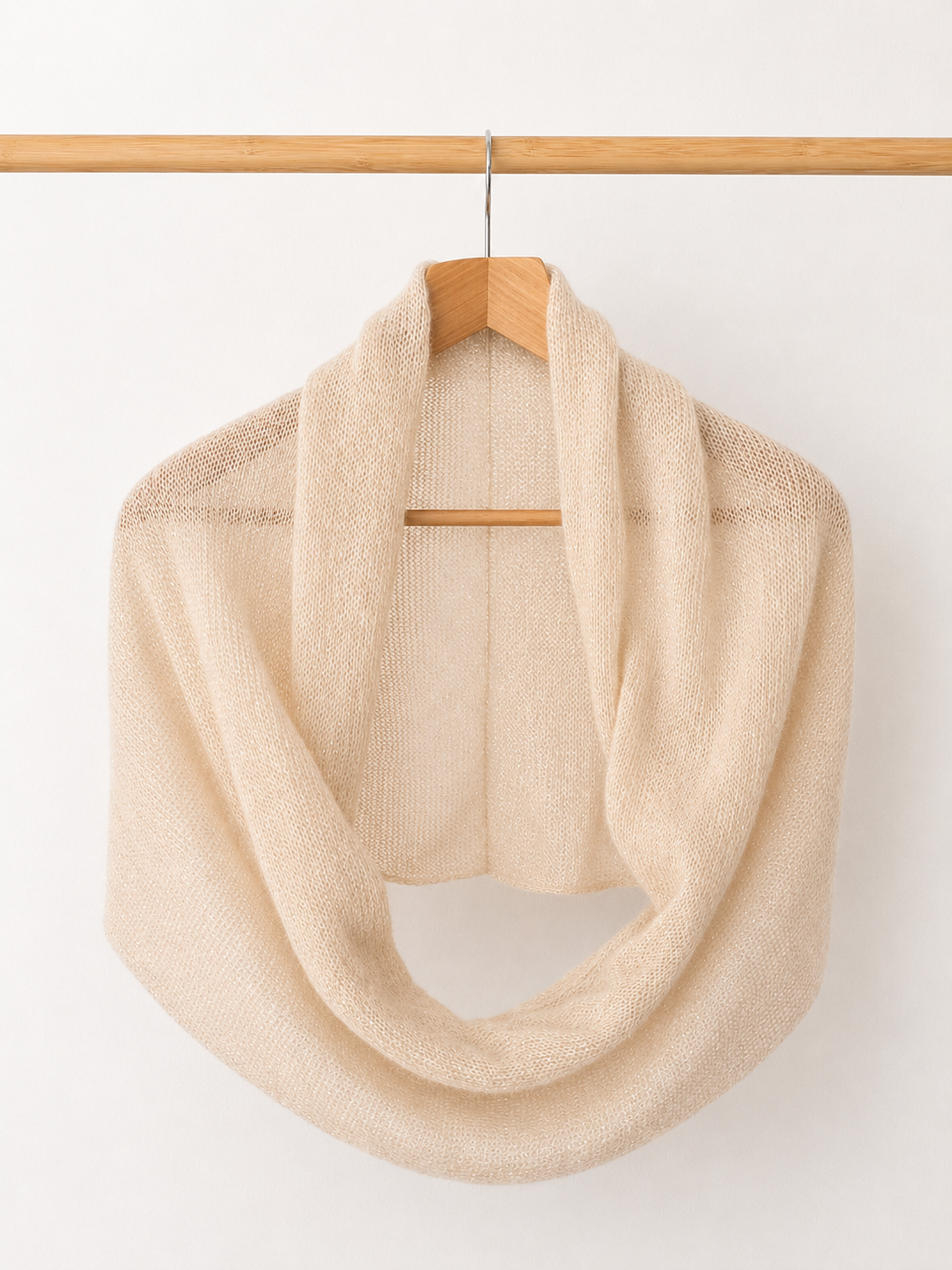 Light Champagne Infinity Scarf hanging on a wooden hanger.