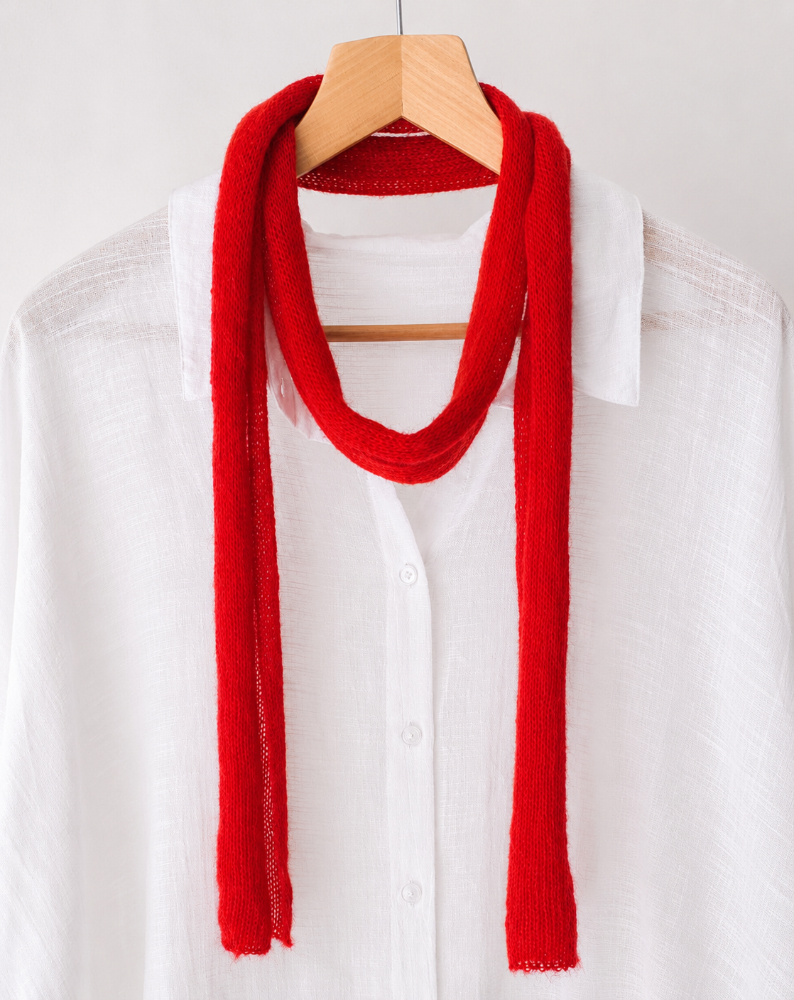 Close-up of the Ruby Red kid mohair scarf highlighting its soft airy texture.
