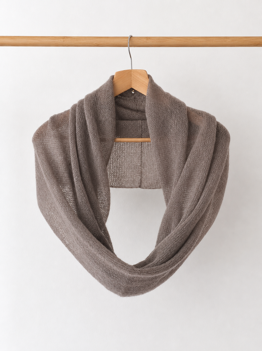Mushroom taupe silk mohair infinity scarf hanging on a wooden hanger.